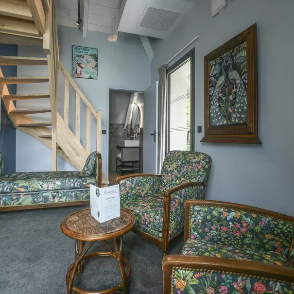 room 31 lounge area with wooden staircase